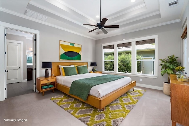 bedroom with a raised ceiling, baseboards, visible vents, and ornamental molding