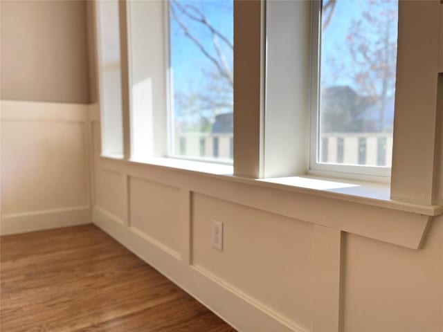 room details with a decorative wall and wood finished floors