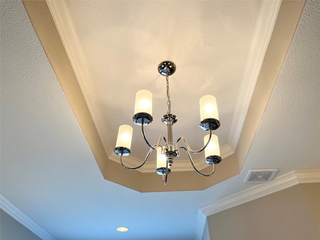 room details featuring crown molding, visible vents, and a chandelier