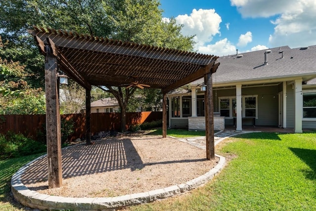 view of yard featuring a patio area, ceiling fan, and fence