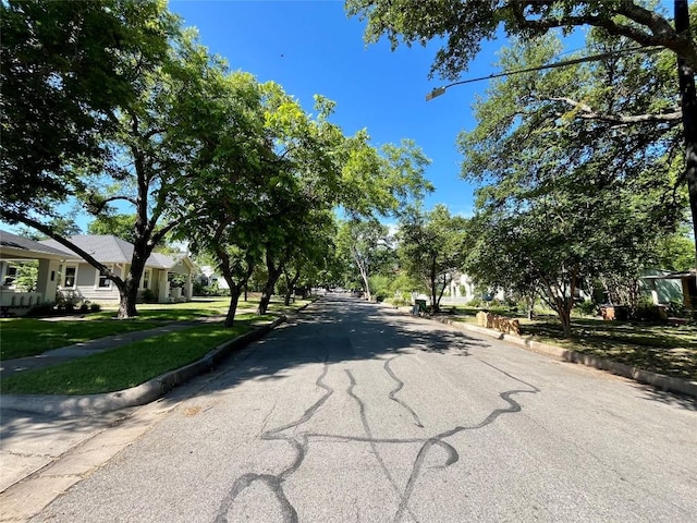 2204 Lindell Ave, Austin, TX 78704 - view of asphalt street with curbs, sidewalks, and street lights