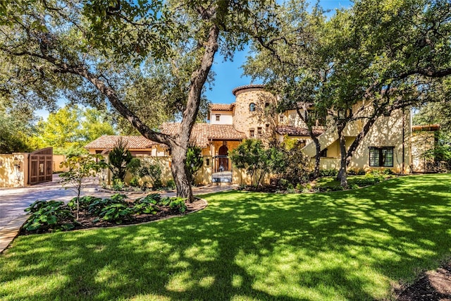 mediterranean / spanish-style home featuring a front yard