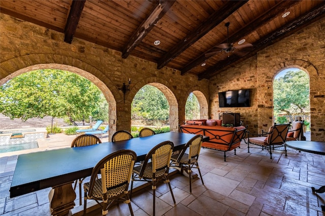 view of patio featuring an outdoor living space with a fireplace