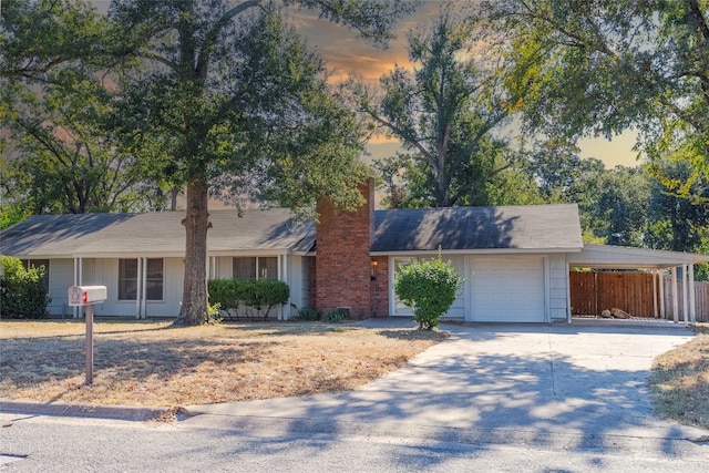 ranch-style house featuring a garage and a carport