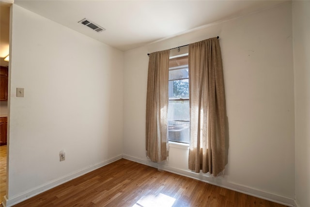 unfurnished room with light wood-type flooring