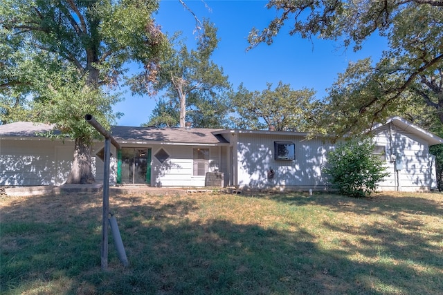 rear view of house with a lawn