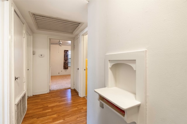 hallway with light hardwood / wood-style flooring