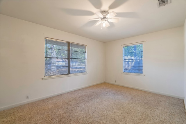 carpeted empty room featuring ceiling fan