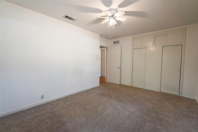 unfurnished bedroom featuring ceiling fan, a closet, and carpet flooring