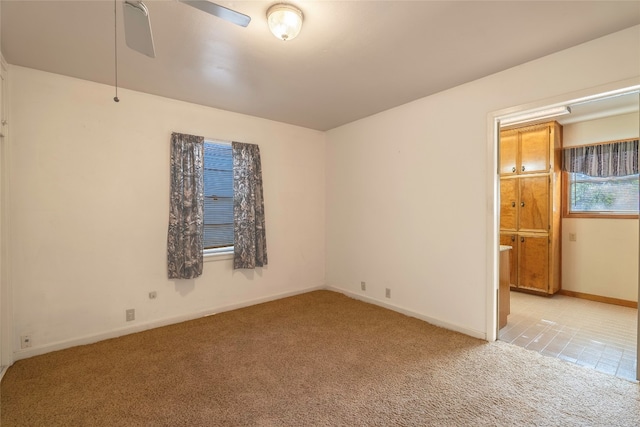 empty room with light carpet and ceiling fan