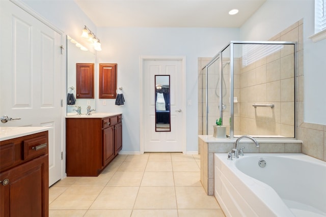 bathroom with vanity, shower with separate bathtub, and tile patterned floors