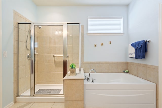 bathroom featuring tile patterned floors and shower with separate bathtub