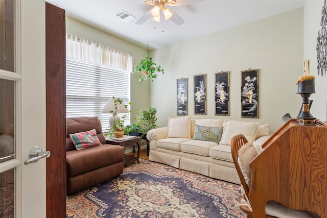 living room with wood-type flooring and ceiling fan