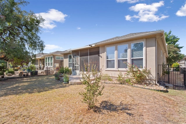 rear view of house with a yard