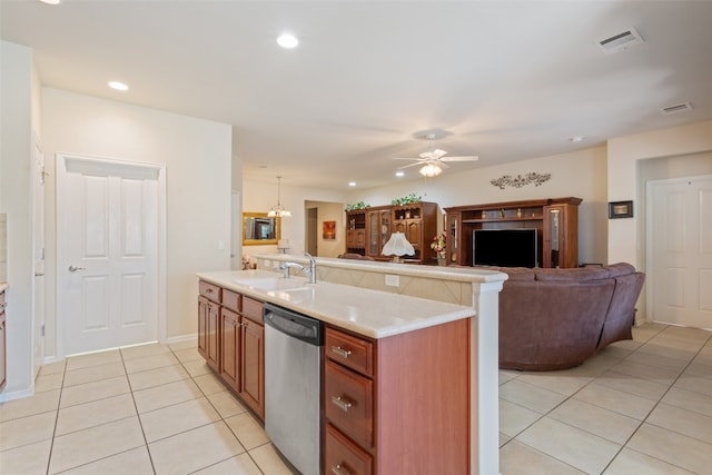 kitchen with ceiling fan with notable chandelier, sink, dishwasher, hanging light fixtures, and an island with sink