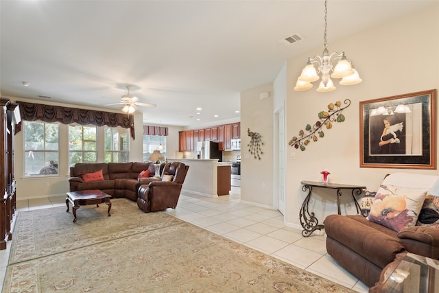 living room featuring ceiling fan with notable chandelier and light tile patterned flooring