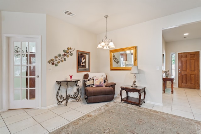 sitting room with a notable chandelier and light tile patterned floors