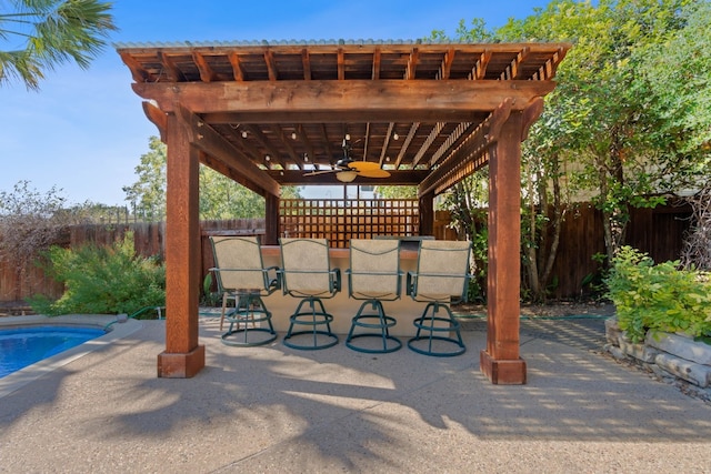 view of patio with ceiling fan, a fenced in pool, and a pergola