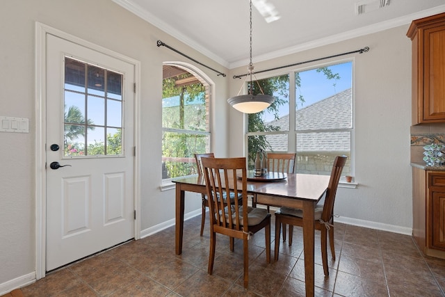 dining space with crown molding