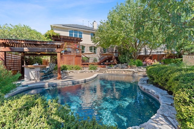 view of swimming pool with a wooden deck, a patio area, and a pergola