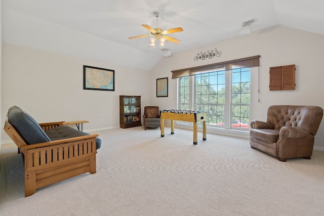 living area featuring lofted ceiling, ceiling fan, and carpet flooring