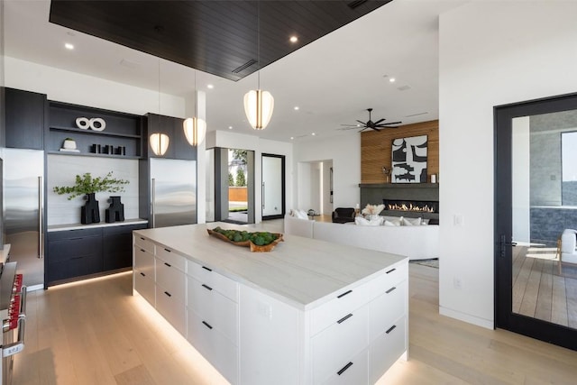 6809 Oasis Pass, Austin, TX 78732 - kitchen featuring built in fridge, modern cabinets, light wood-type flooring, white cabinetry, and recessed lighting