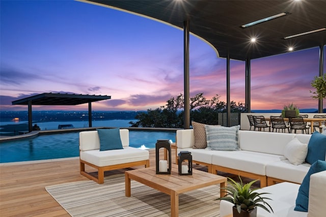 exterior space with an outdoor hangout area and a deck with water view