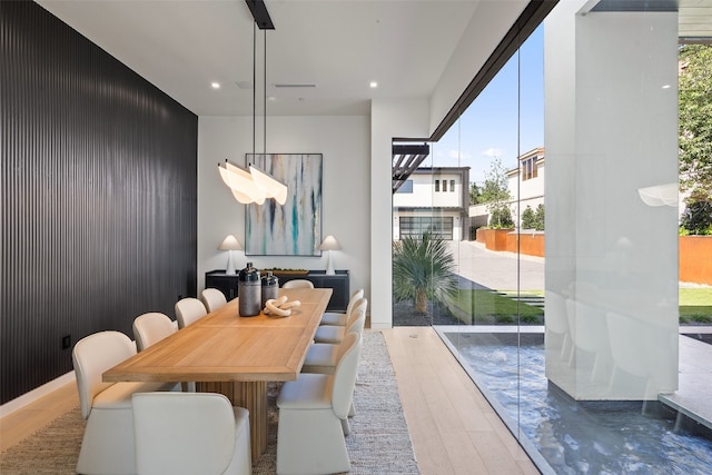 dining room featuring hardwood / wood-style flooring and a healthy amount of sunlight