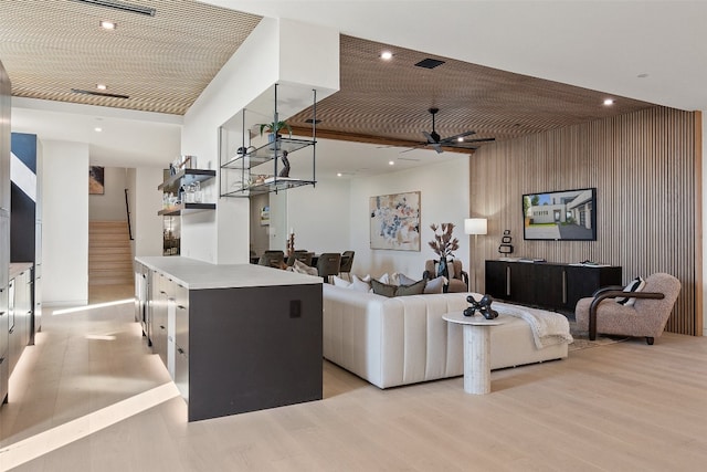 living room with light hardwood / wood-style flooring and ceiling fan