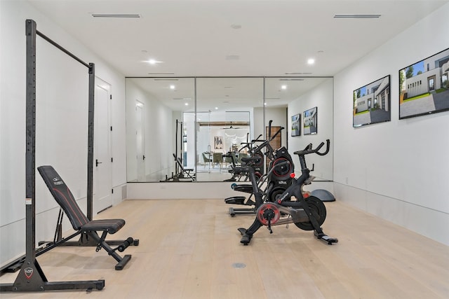 exercise area with light hardwood / wood-style flooring