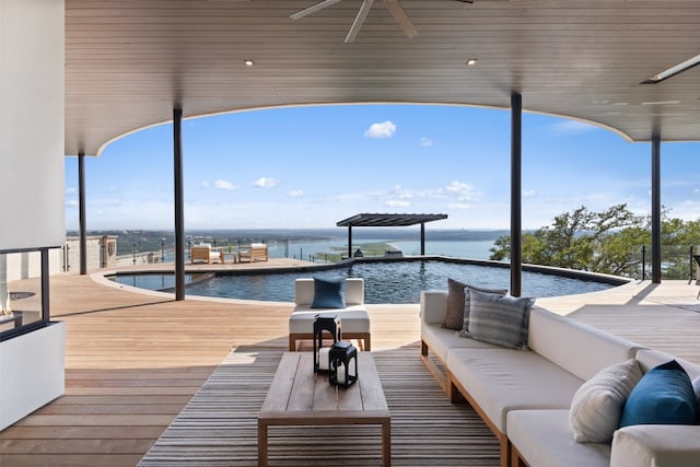 exterior space with ceiling fan, an outdoor living space, and a water view