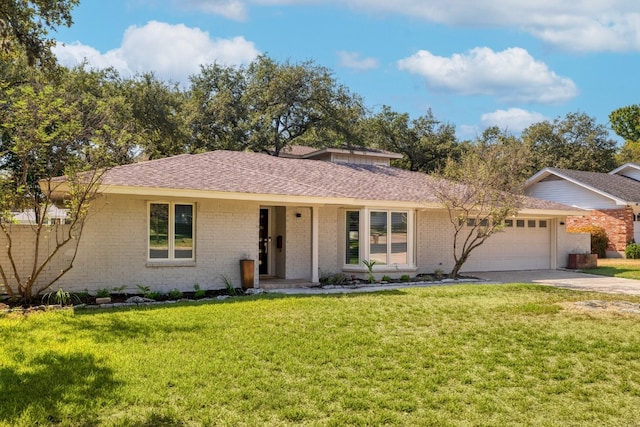 ranch-style house featuring a garage and a front lawn