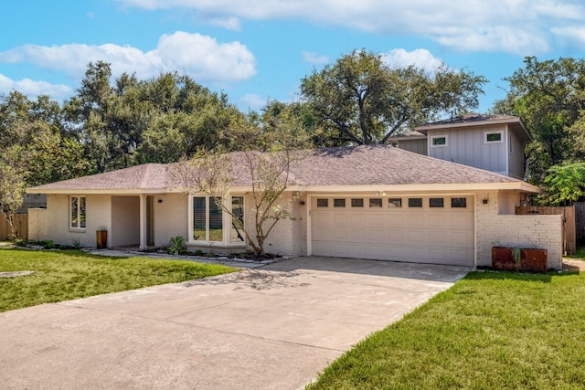 view of front of home with a front lawn and a garage