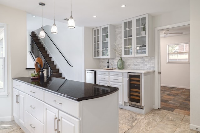 kitchen featuring tasteful backsplash, pendant lighting, white cabinets, and wine cooler