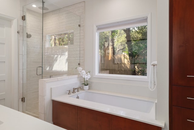 bathroom featuring separate shower and tub