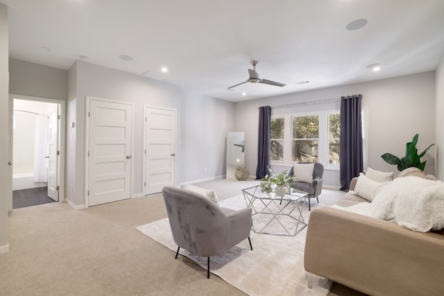 living room with ceiling fan and light colored carpet