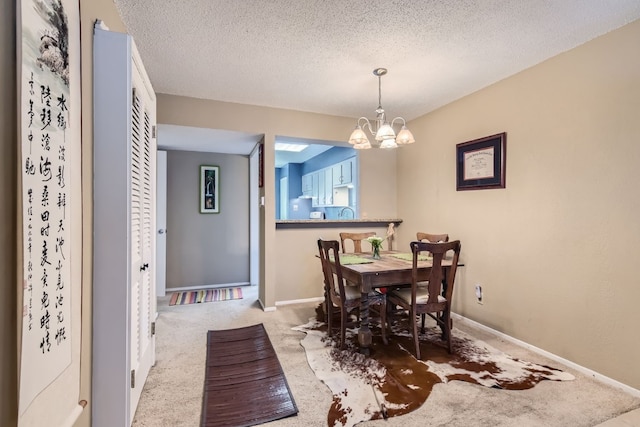 carpeted dining space featuring an inviting chandelier and a textured ceiling