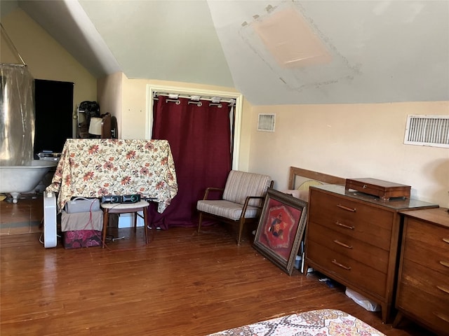 living area featuring lofted ceiling and dark wood-type flooring