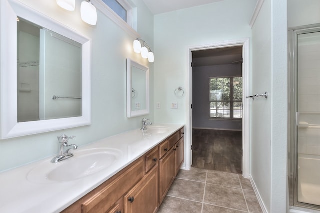 bathroom featuring an enclosed shower, tile patterned flooring, and vanity