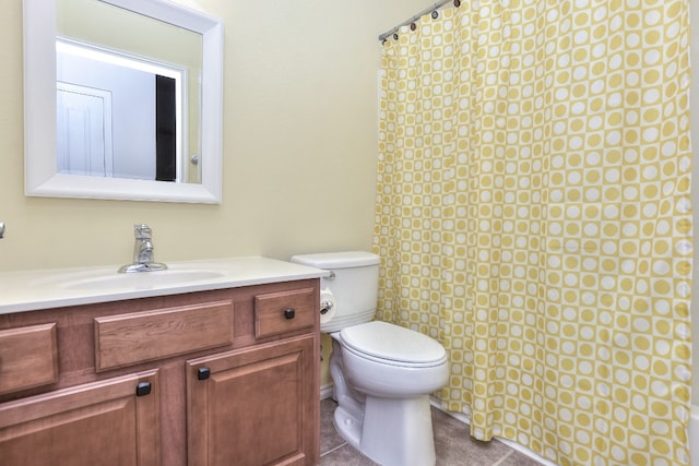 bathroom featuring tile patterned floors, vanity, and toilet