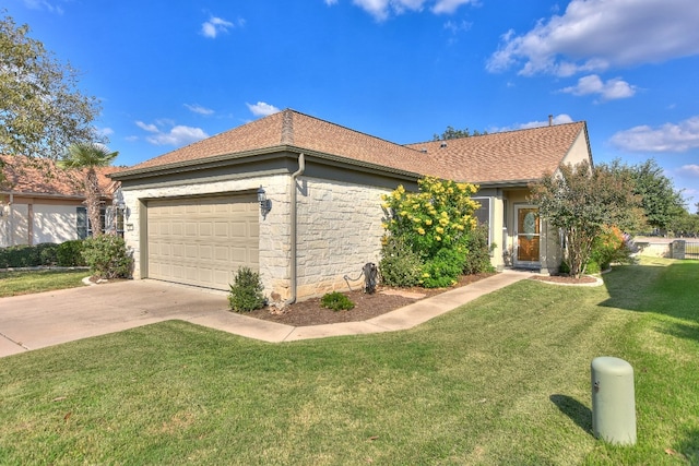 view of front of property with a front lawn and a garage