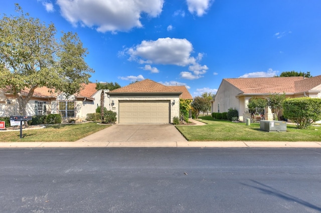 view of front of house featuring a front lawn and a garage