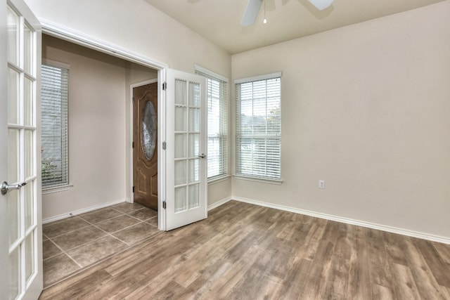 foyer with ceiling fan, french doors, and dark hardwood / wood-style flooring