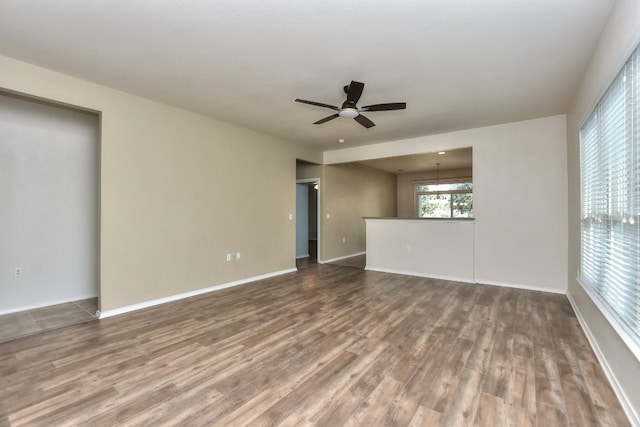 spare room featuring wood-type flooring and ceiling fan