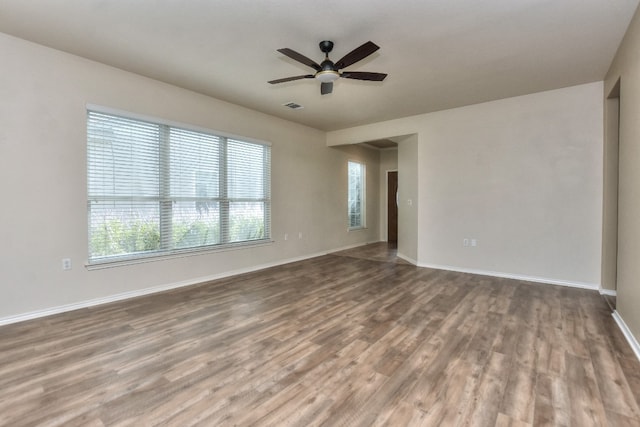 unfurnished room with hardwood / wood-style flooring and ceiling fan