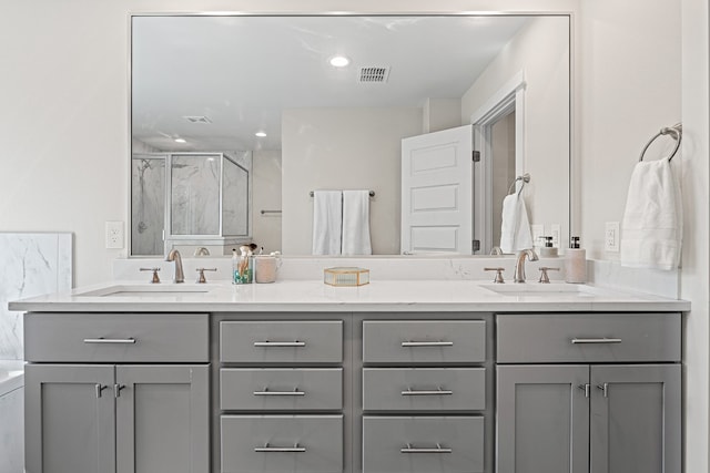 bathroom featuring vanity and a shower with door