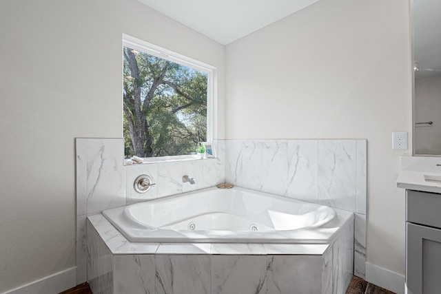 110 E Holland St, San Marcos, TX 78666 - full bath with vanity, baseboards, and a whirlpool tub