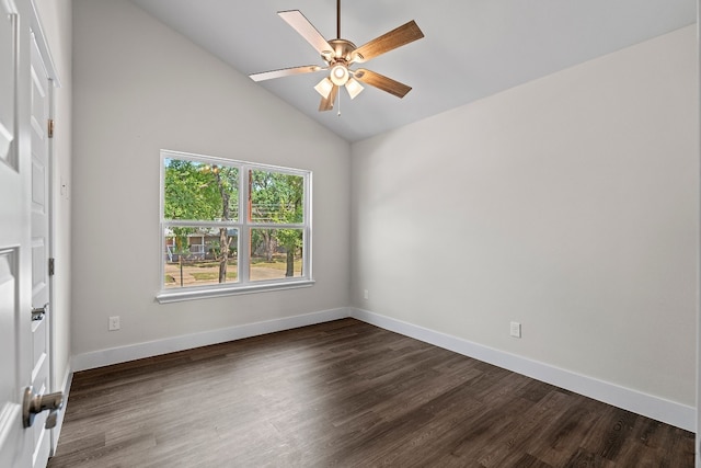 spare room featuring dark wood-type flooring, ceiling fan, and vaulted ceiling