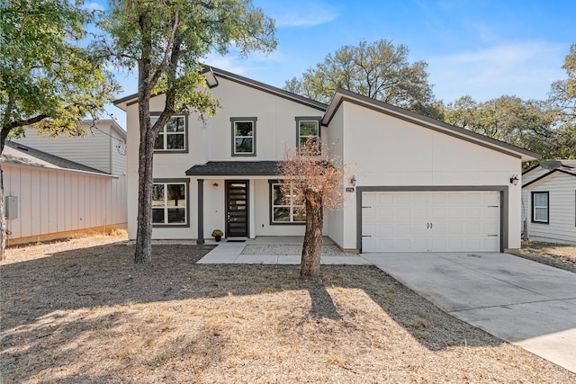 110 E Holland St, San Marcos, TX 78666 - view of front of house with an attached garage, driveway, and stucco siding