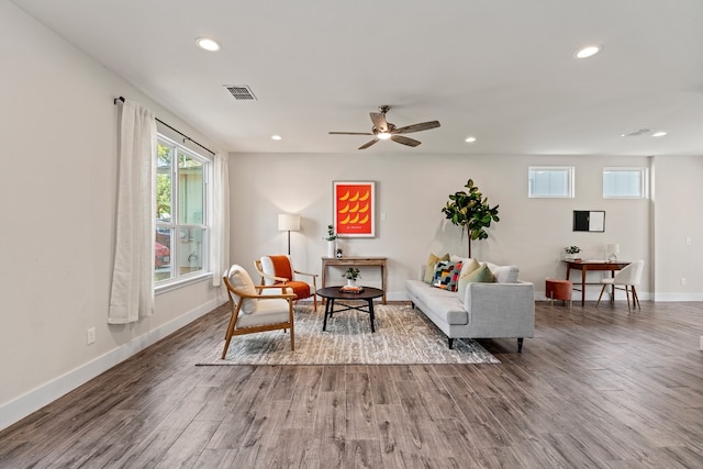 living room with hardwood / wood-style floors, a wealth of natural light, and ceiling fan